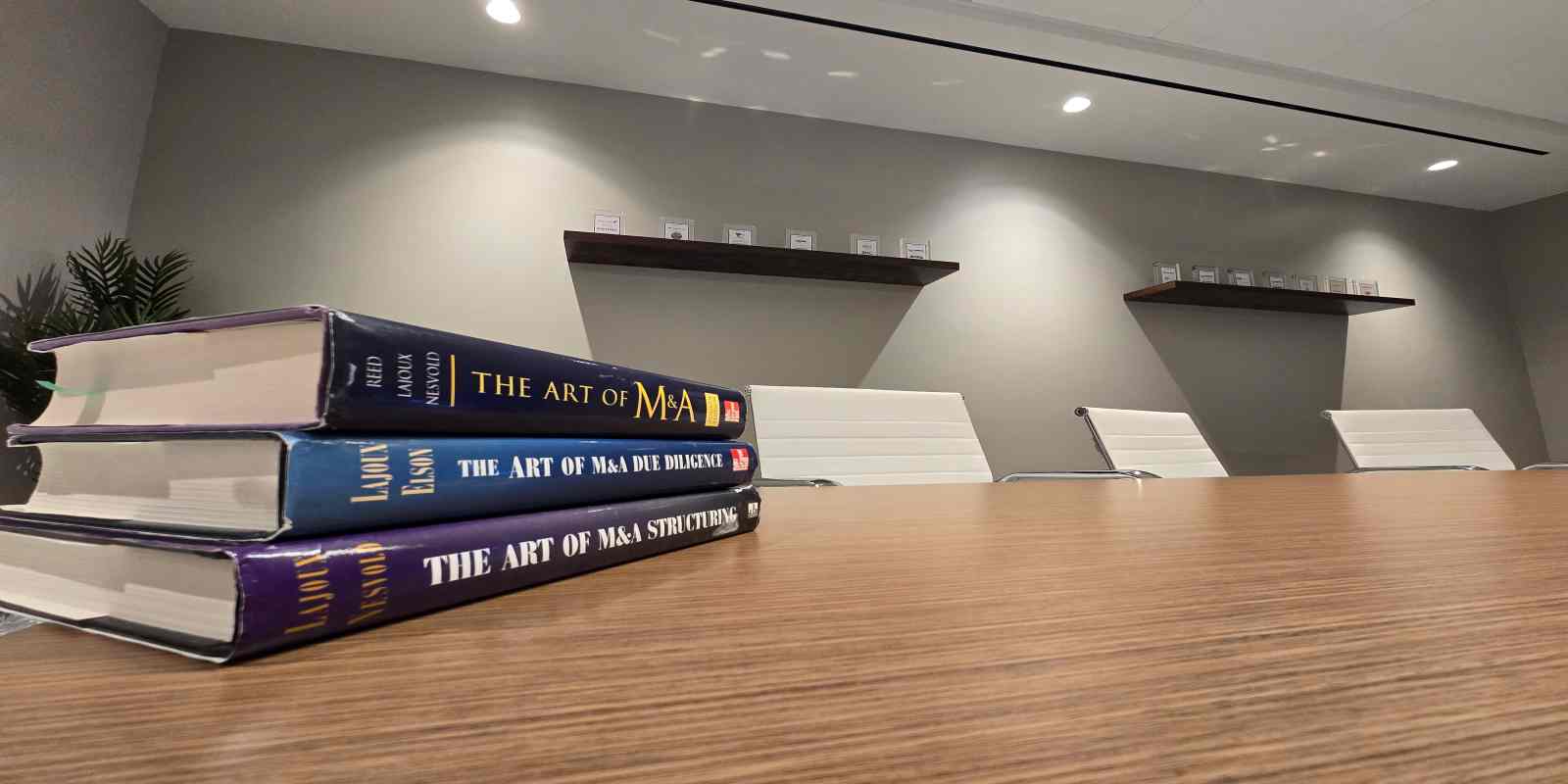 Three Books of The Art of M&A are Kept on Table