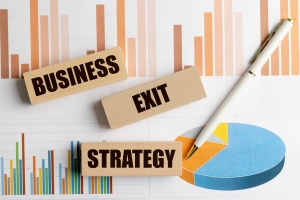Wooden Blocks with Text Business Exit Strategy on Financial Charts