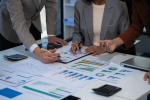 Group of Professional Buyers Calculating Business Valuation Using Financial Charts